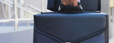 Midsection view of businessman holding briefcase